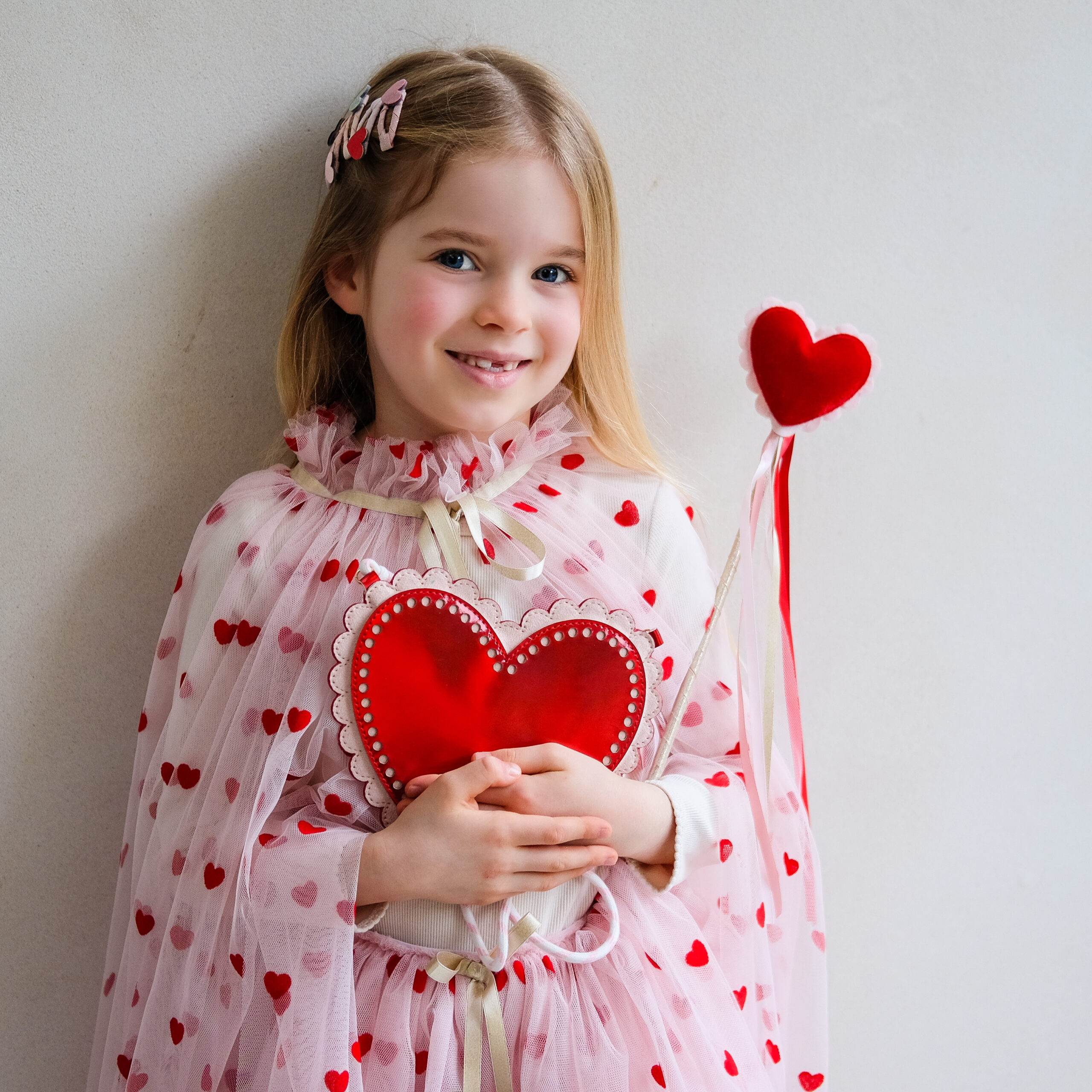 182092 27 HEART MINI CLIC CLACS, 183003 14 SCALLOPED HEART BAG, 185002 27 HEART PRINT TUTU, 185003 27 HEART PRINT CAPE & 185004 27 HEART WAND